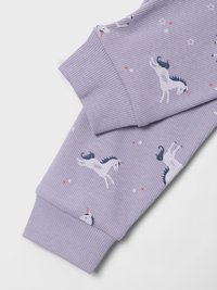 Lavender ribbed fabric with unicorn print, featuring colorful accents and small stars. Cuffs are designed for a snug fit.