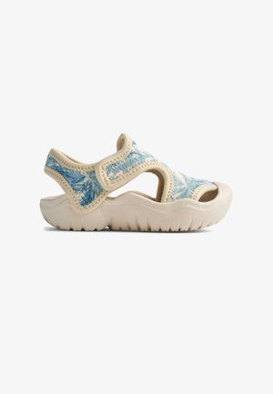 Lightweight sandals with a blue palm leaf pattern on a soft, beige material. Open design and textured sole for traction.