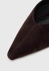 Dark brown suede pointed-toe shoe with a smooth texture and minimal stitching details, designed to fit snugly around the foot.