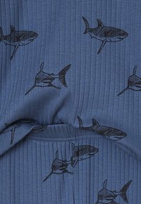 Blue ribbed fabric with a repeating pattern of black hand-drawn sharks swimming in various directions.