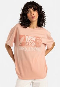 Light pink cotton t-shirt featuring a graphic design with surfboard, spiral, and palm tree motifs. Relaxed fit with short sleeves.