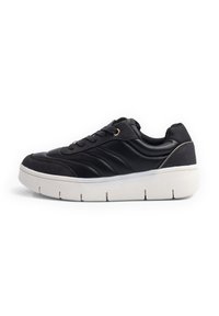 Black athletic shoe featuring a textured leather upper, contrasting smooth accents, lace-up closure, and a thick white sole with ridges.