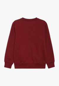 Felpa bordeaux con maniche lunghe, colletto a girocollo a costine e polsini. Realizzata in morbido tessuto testurizzato; design semplice senza ulteriori decorazioni.