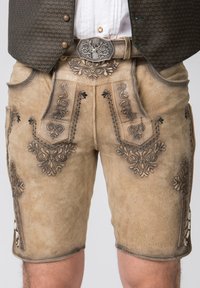 Beige lædershorts med detaljeret mørk broderi og sidelommer, suppleret af en dekorativ metalbæltespænde.