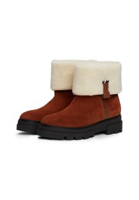 Bruine suède enkellaarsjes met een crèmekleurige nepbontrand, donkere rubberen zolen en een bruine leren accent bij de hiel.