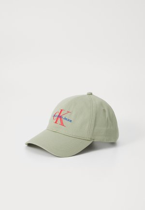 Green cotton cap with a curved brim, featuring red and blue embroidered logo "CK Calvin Klein Jeans" on the front.