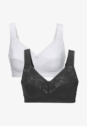 White wireless bra featuring floral lace overlay, wide straps, and a smooth texture. Notable v-neck design with a small center bow detail.