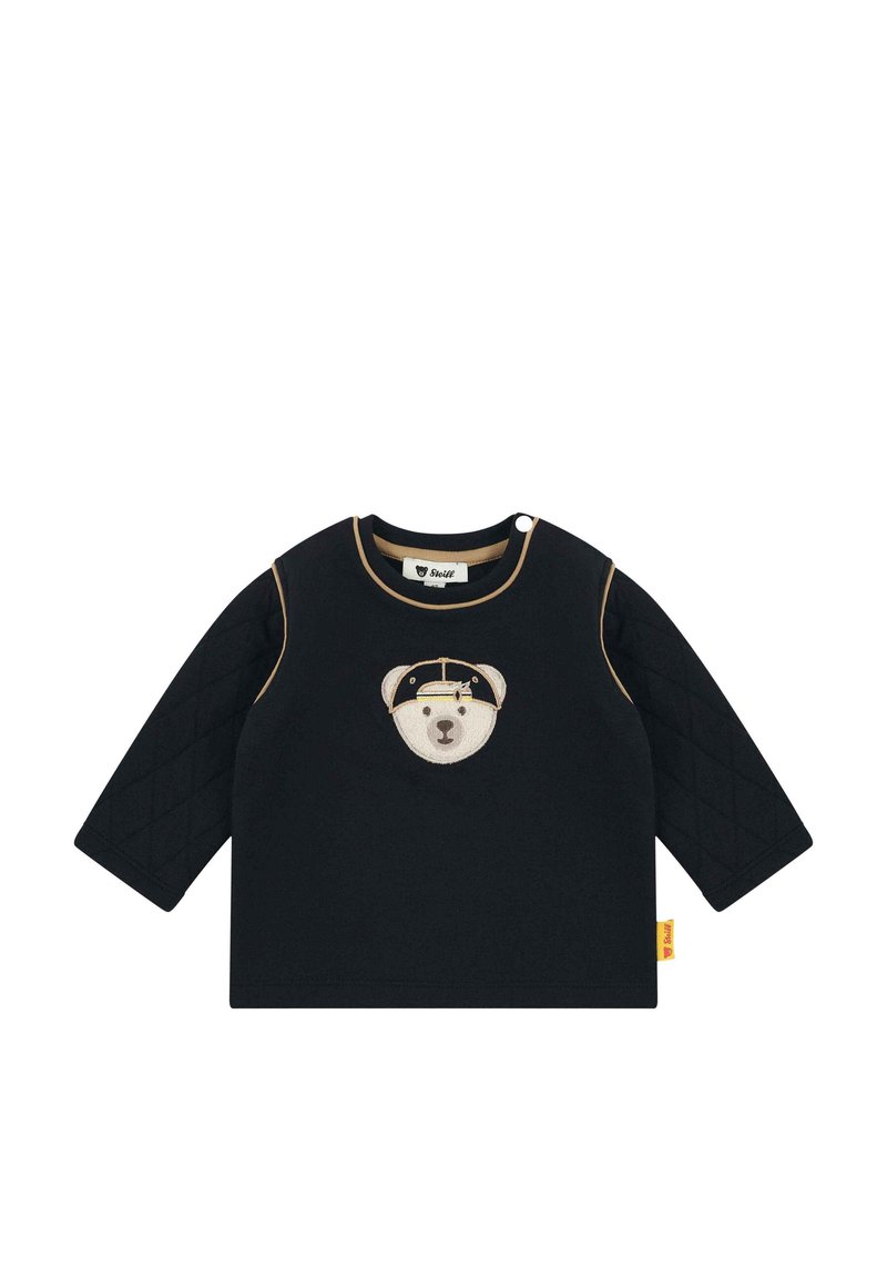 Schwarzes Langarmshirt mit einer gesteppten Textur an den Ärmeln, mit einem aufgestickten Bärenkopf auf der Vorderseite und kontrastierenden Besätzen.