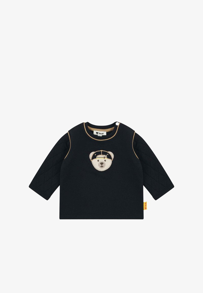 Schwarzes Langarmshirt mit einer gesteppten Textur an den Ärmeln, mit einem aufgestickten Bärenkopf auf der Vorderseite und kontrastierenden Besätzen.