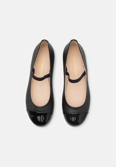 Svart läderballetflats med en glänsande svart lacktåkap och en rosa insida. Har ett delikat band över fotryggen.