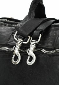 Bolso de cuero negro con herrajes plateados, cierres de doble cremallera y asas resistentes. La superficie texturizada añade profundidad.