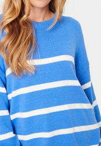 Pull à rayures bleues avec des rayures horizontales blanches, en tissu tricoté, doté d'une coupe décontractée et d'un col et poignets côtelés.