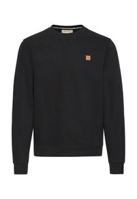 Svart langermet crewneck sweatshirt med ribbestrikkede mansjetter og et lite firkantet brunt logo-patch på venstre bryst.