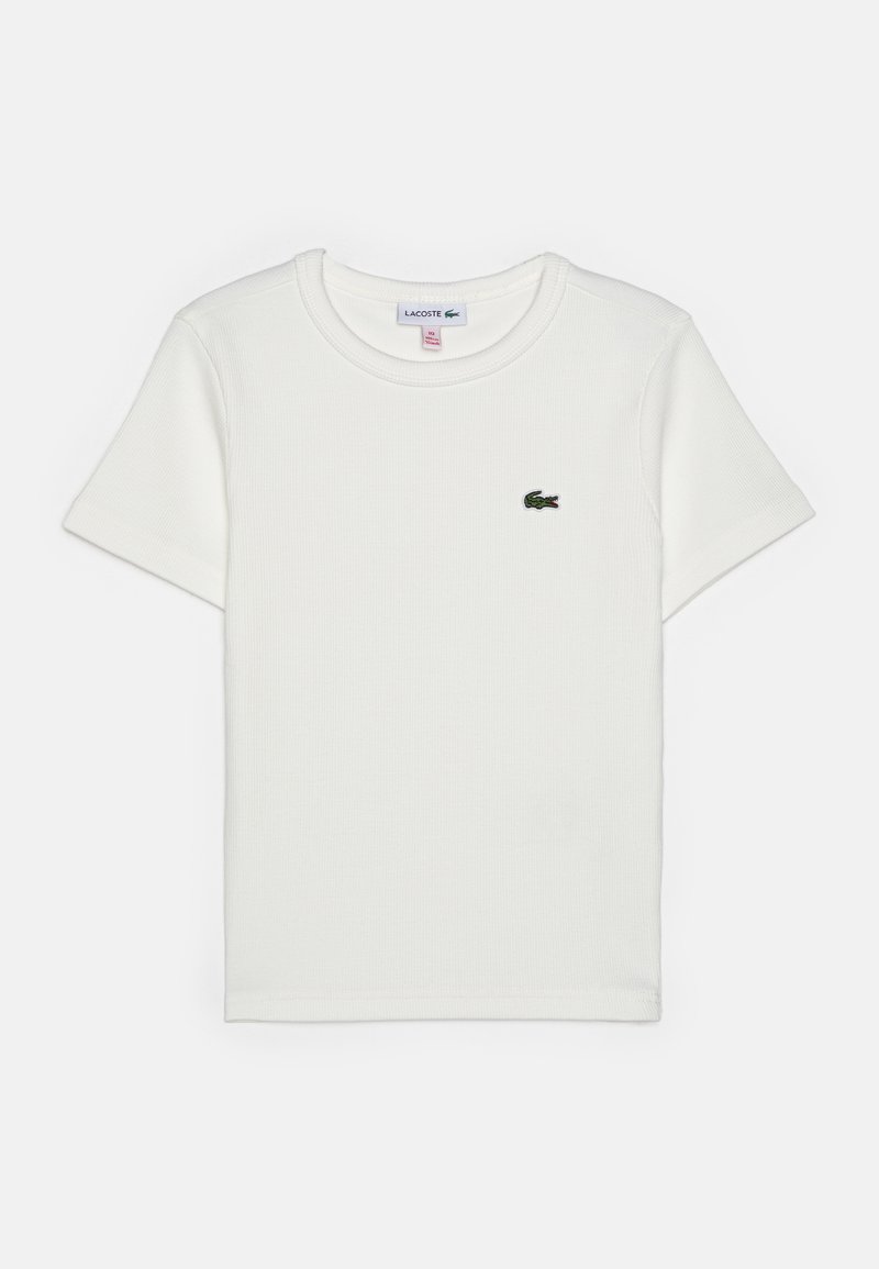 Λευκό κοντομάνικο ριπ μπλουζάκι με στρογγυλή λαιμόκοψη και μικρό πράσινο λογότυπο κροκόδειλου Lacoste στο αριστερό στήθος.