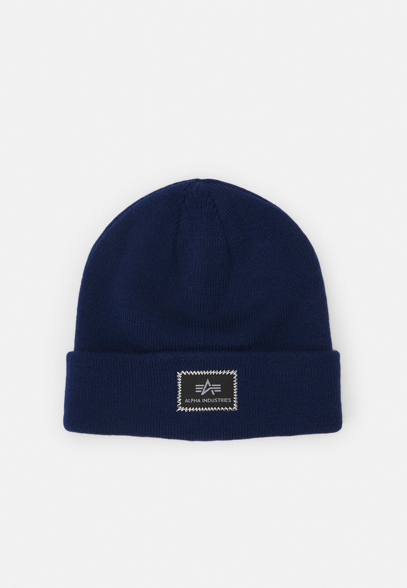 Námornícka modrá pletená čiapka s ohnutým lemom a čiernou obdĺžnikovou značkou so bielym textom a detailmi vyšívania.