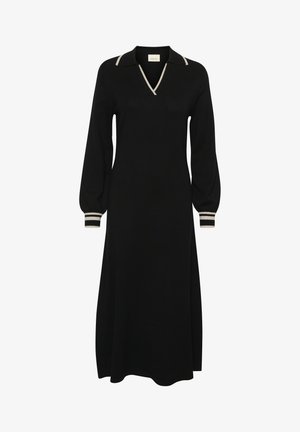 Musta mekko, jossa on V-päänti ja vaaleanbeige koristus sekä pitkät pallopaisutetut hihat. Koristeluina on raidalliset hihansuut, jotka tarjoavat rentoa istuvuutta.