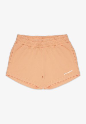 Nohavice v broskyňovej farbe vyrobené z mäkkého materiálu, s elastickým pásom, bočnými vreckami a malým bielym logom "PEGADOR" na prednej strane.