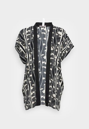 Black and cream patterned kimono-style top with short sleeves, featuring a bold black trim and abstract leaf-like designs.