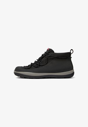 Black ankle-high shoes with a textured upper, featuring laces and a grey sole, displayed from the side against a white background.