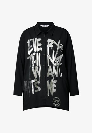 Black button-up shirt with silver graffiti-style text reading "EVERYTHING I WANT," featuring a smiley face graphic. Long sleeves, relaxed fit.