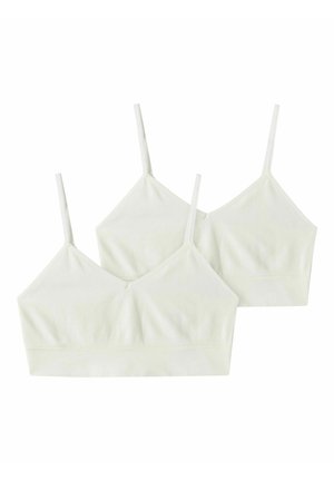 Deux soutiens-gorge blancs sans couture et doux avec des bretelles fines et réglables disposés en chevauchement sur un fond blanc.