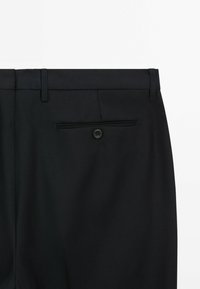 Black trousers with a smooth texture, featuring a single back pocket with a button closure and belt loops at the waist.