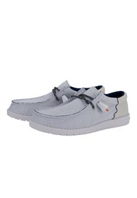 Zapatos slip-on de color gris claro con una parte superior de tela texturizada, costuras en contraste y una suela de goma blanca. Cuenta con cordones decorativos y acentos.