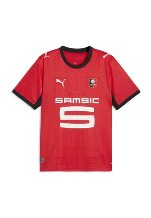 Czerwona koszulka piłkarska Stade Rennais z czarnym kołnierzem i obramowaniem rękawów, białymi logo Puma, herbem klubu oraz logo sponsora Samsic z przodu.
