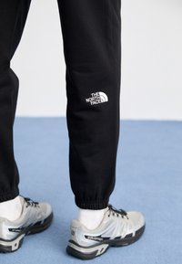 The North Face ESSENTIAL JOGGER - Pantalones deportivos - black