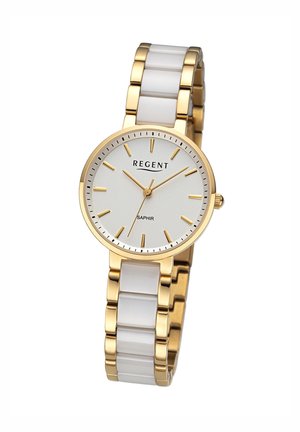 Montre dorée avec bracelet en céramique blanche, cadran rond argenté, marqueurs d'heure et aiguilles dorés. Présente le nom de la marque "REGENT" et "SAPHIR."