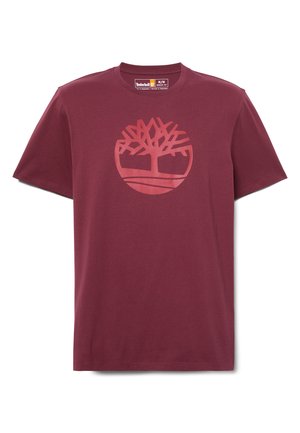 T-shirt di cotone color marrone scuro con un grafiche circolare che rappresenta un albero con radici e una linea orizzontale, colletto tondo e maniche corte.