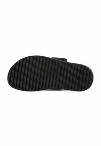 Zwarte rubberen zool met diepe groeven voor grip, met een gladde bovenkant en een ronde vorm, ontworpen voor comfort en stabiliteit.