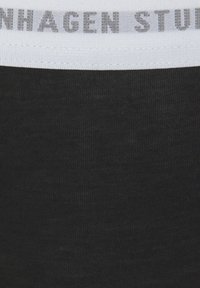 Black fabric with a fine texture featuring a white waistband displaying "Copenhagen Studios" in gray lettering.