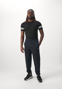 Champion ICONS ELASTIC CUFF PANTS LOOSE FIT - Tepláky - dark blue