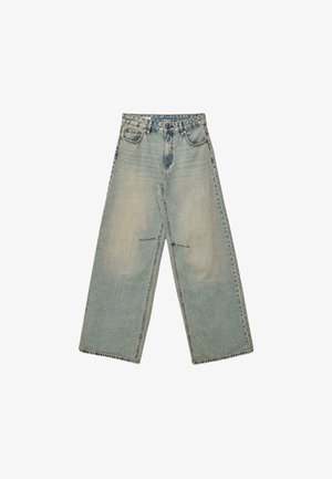 Jeans in denim blu a gamba larga con un lavaggio sbiadito, cinque tasche e chiusura con zip e bottone. Cuciture evidenti lungo l'orlo.