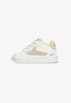 White sneaker with beige suede accents, round toe, lace-up design, textured rubber sole, and decorative turquoise dots on the heel.