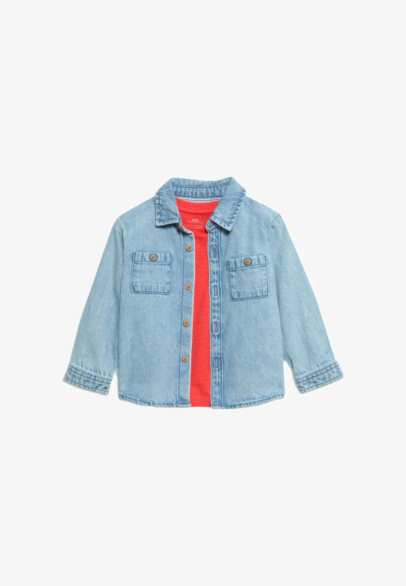 Jasnoniebieska kurtka dżinsowa z długimi rękawami, zapinana na guziki, z dwiema kieszeniami na piersi i brązowymi guzikami. Nosi się ją na czerwonej koszuli.