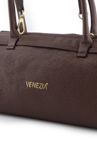 Brown textured leather handbag with dual handles and gold hardware. Features the brand name "VENEZIA" embossed in gold.