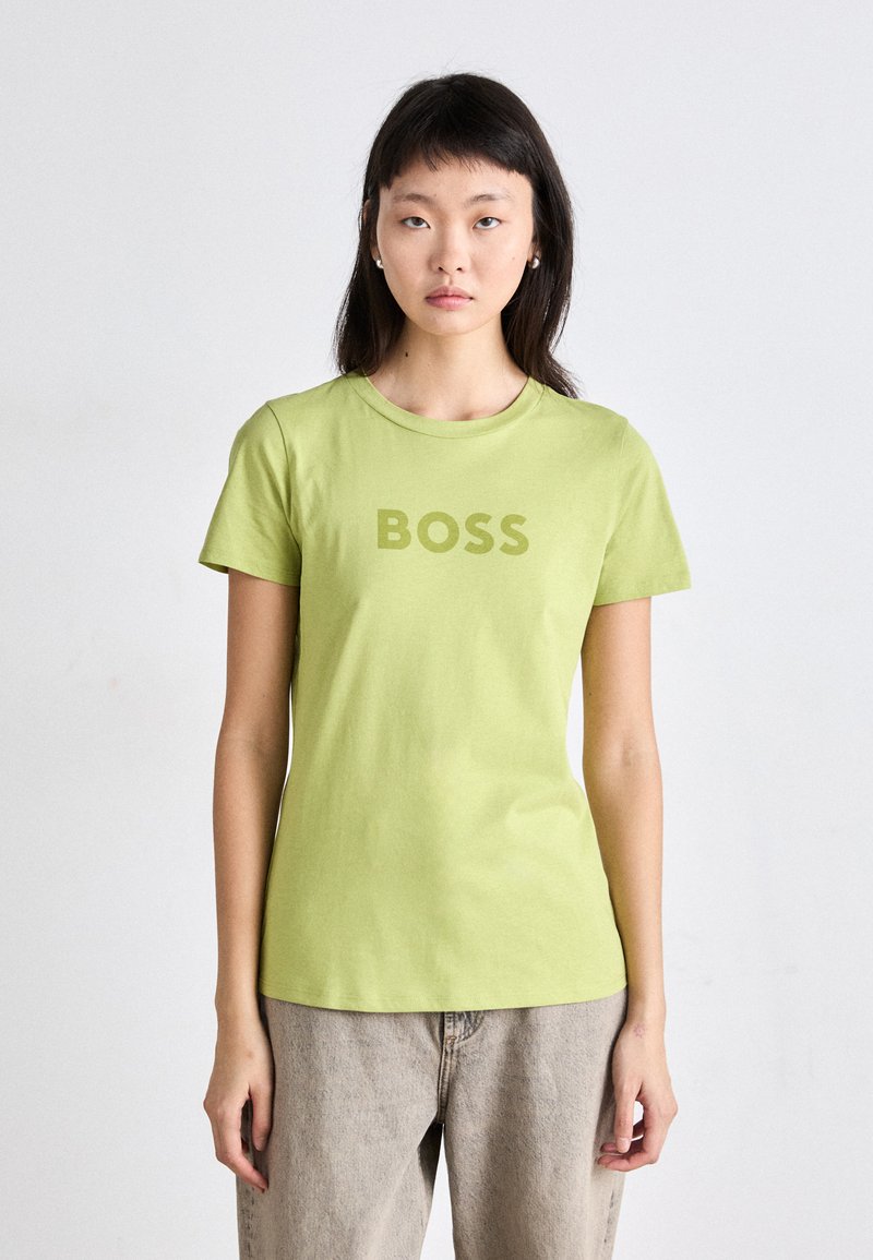 Short-sleeve, crew neck T-shirt in light green cotton, featuring a large "BOSS" print in a matching shade across the chest.