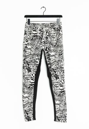 Leggings a motivo bianco e nero con un design testurizzato, vestibilità slim e una sezione nera uniforme lungo i lati.