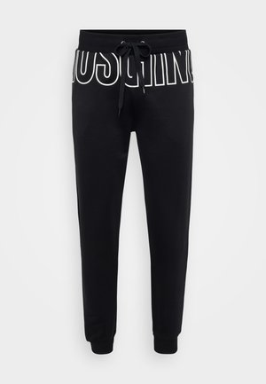 Fekete, puha anyagból készült melegítőnadrág, állítható derékkal, elöl fehér logónyomattal, összehúzott szárakkal és bordázott mandzsettákkal.