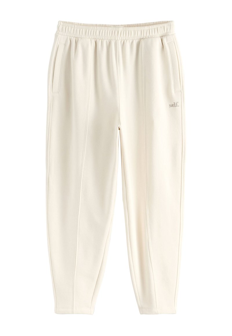 Kreminės spalvos laisvalaikio kelnės su elastiniu juosmeniu, šoniniais kišenėmis ir subtiliomis siuvimo detalėmis. Pagamintos iš minkštos medžiagos, suteikiančios komfortą.
