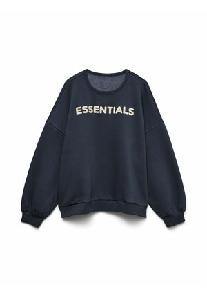 Sweat-shirt noir surdimensionné avec le texte "ESSENTIALS" en blanc sur la poitrine, doté de manches longues bouffantes et de poignets et ourlet côtelés.