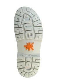 Semelle en caoutchouc blanche avec un motif texturé, ornée d'un logo étoile orange et du nom de la marque embossé "THE ART COMPANY."