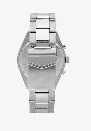 Roestvrijstalen horloge met een gepolijste afwerking, stevige schakels en een rechthoekige kast. Beschikt over een logo en drukknoopsluiting. Ronde wijzerplaat zichtbaar.