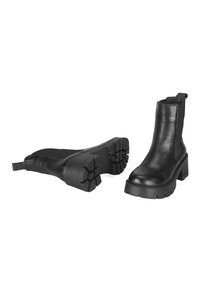 Bottines en cuir noir avec une semelle en caoutchouc épaisse, des panneaux latéraux élastiques et une languette à l'arrière pour un enfilage facile.