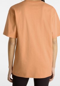 T-shirt a maniche corte in cotone arancione chiaro, vestibilità comoda, con collo rotondo e orlo dritto, che mostra la vista posteriore.