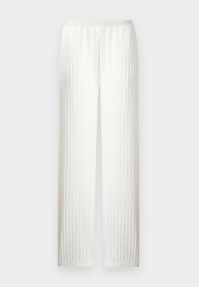 Εκρού πλεκτό παντελόνι με κάθετο καλωδιακό σχέδιο, ίσια γραμμή και ελαστική μέση.