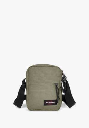 Olive green fabric messenger bag with a black adjustable strap, front zip pocket, and Eastpak logo patch. Rectangular shape, durable texture.