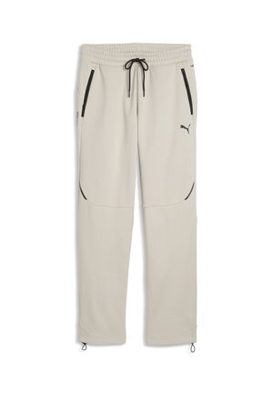 Pantalon de jogging beige clair avec lien noir, poches latérales zippées, logo Puma sur la cuisse droite et ourlets ajustables.